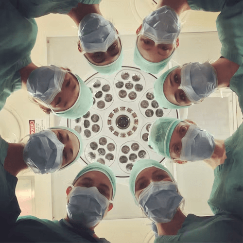 Surgeons gathered around an operating light